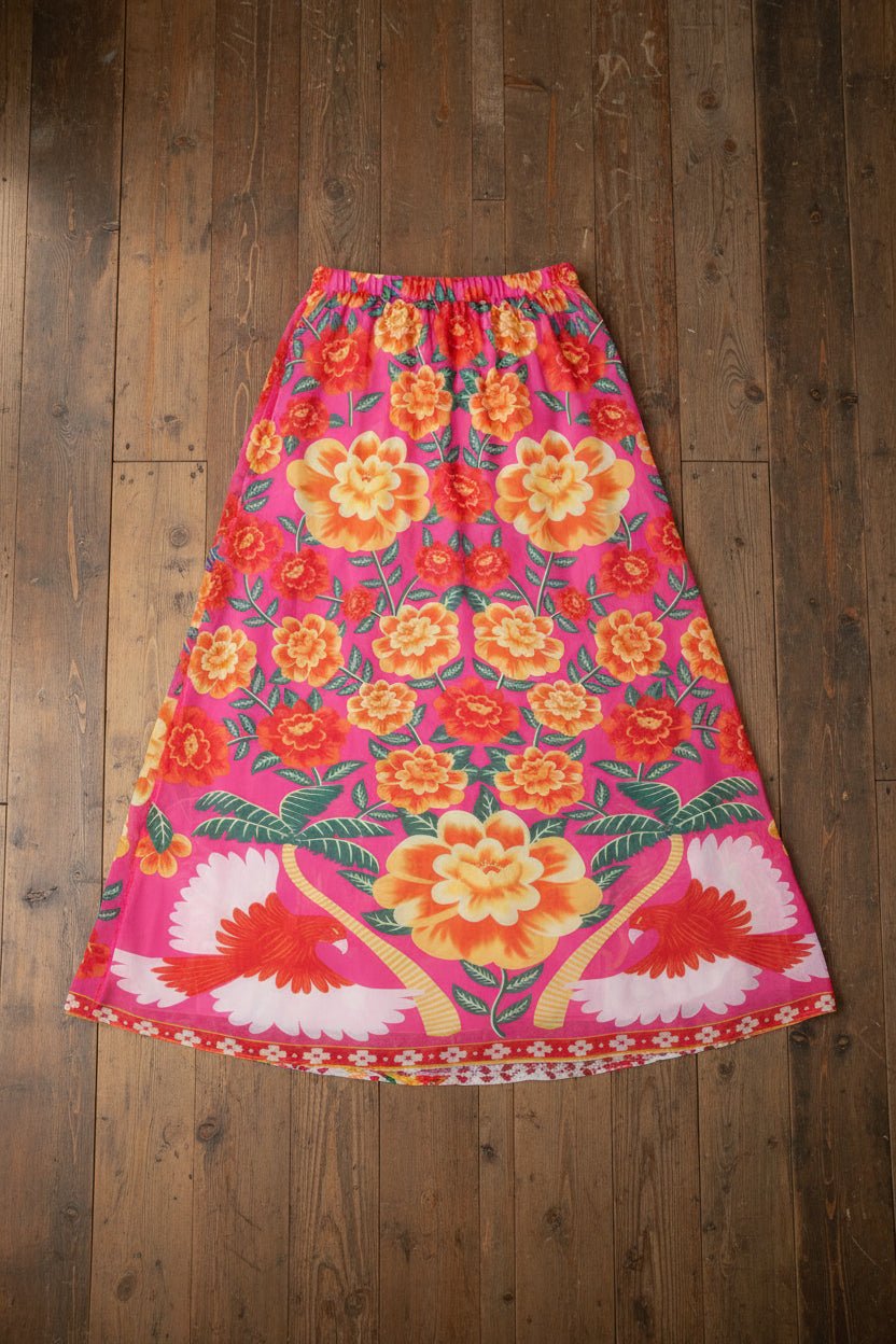 A floral print one-piece swimsuit skirt in shades of pink and orange with a no-back-pocket design.