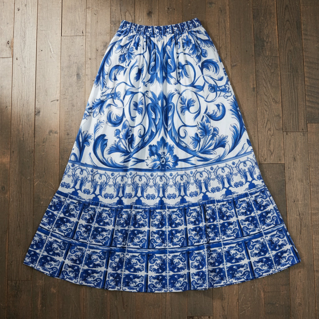 A floral print one-piece swimsuit skirt in blue and white colors with a large bow at the waist.